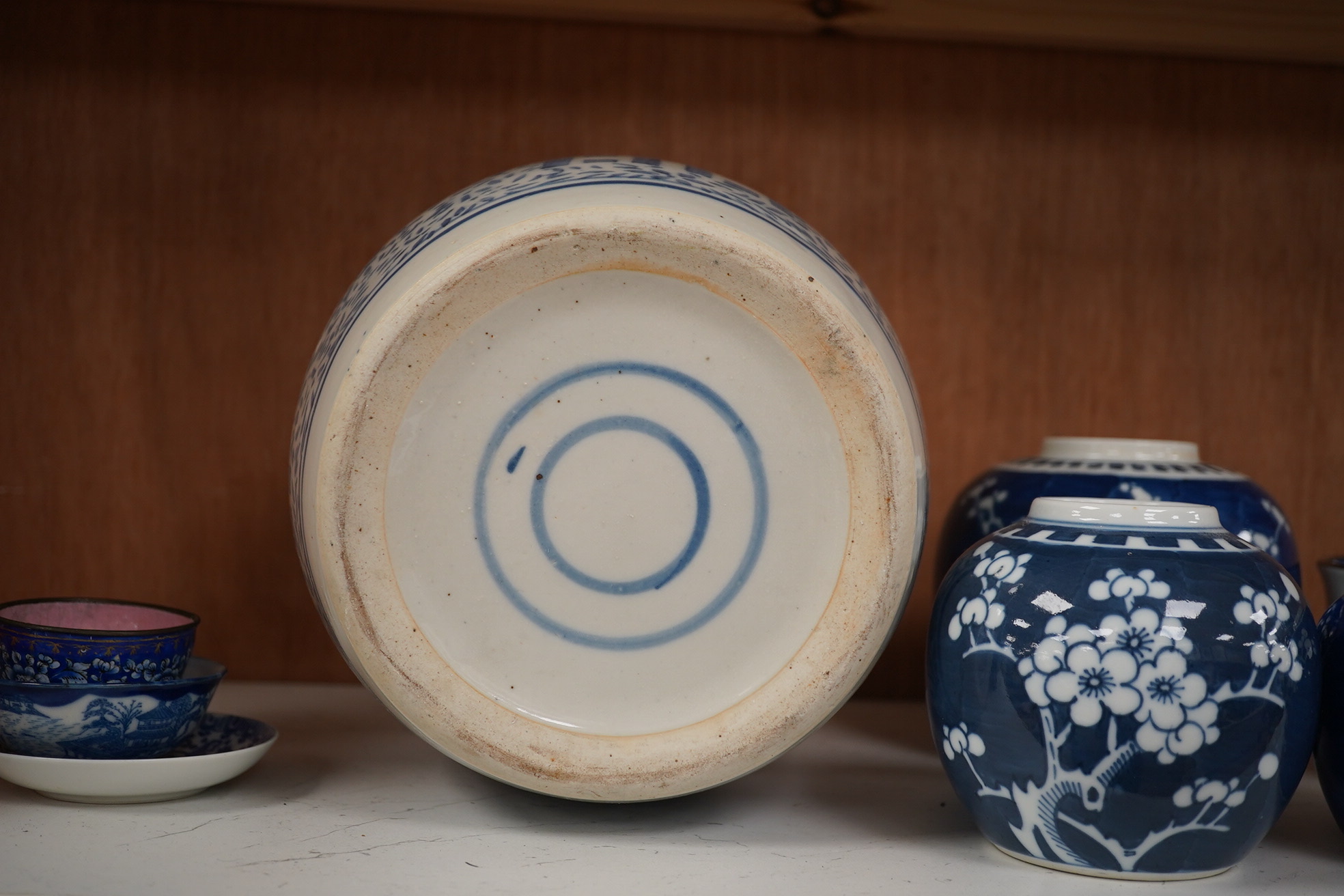 A group of Chinese blue and white porcelain, including a mid 19th century Canton enamel teabowl and a Japanese small dish, tallest 22cm. Condition - fair